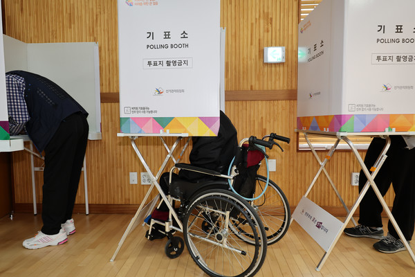 제22대 국회의원 선거 사전투표 첫 날인 5일 오전 서울 광진구 구의제1동 주민센터에 마련된 사전투표소에서 휠체어를 탄 유권자가 기표를 하고 있다. [사진=뉴시스]